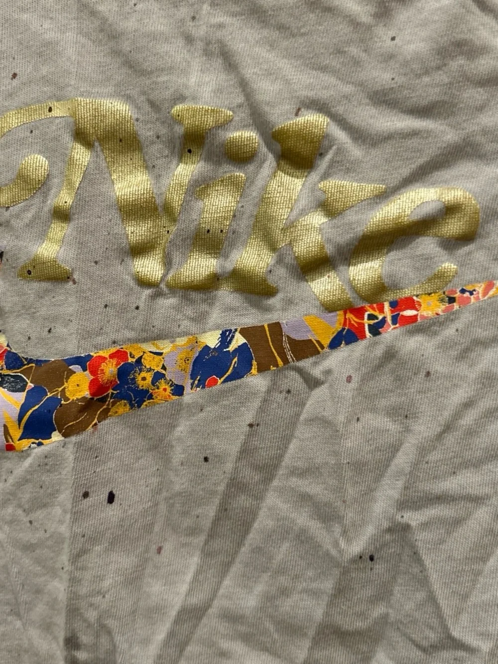 Nike White Tee with Multicolor Floral Swoosh and Gold Script